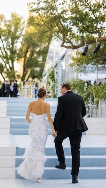 Wedding couple walking toward a ceremony at golden hour