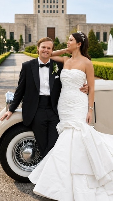 Wedding couple beside a vintage car at an estate venue