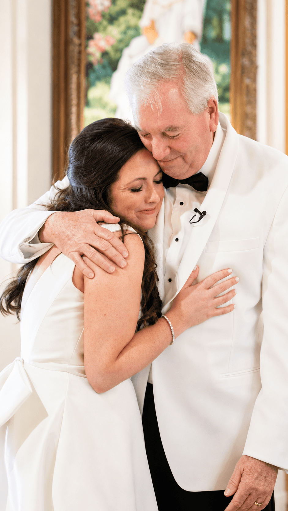 Bride and father embracing
