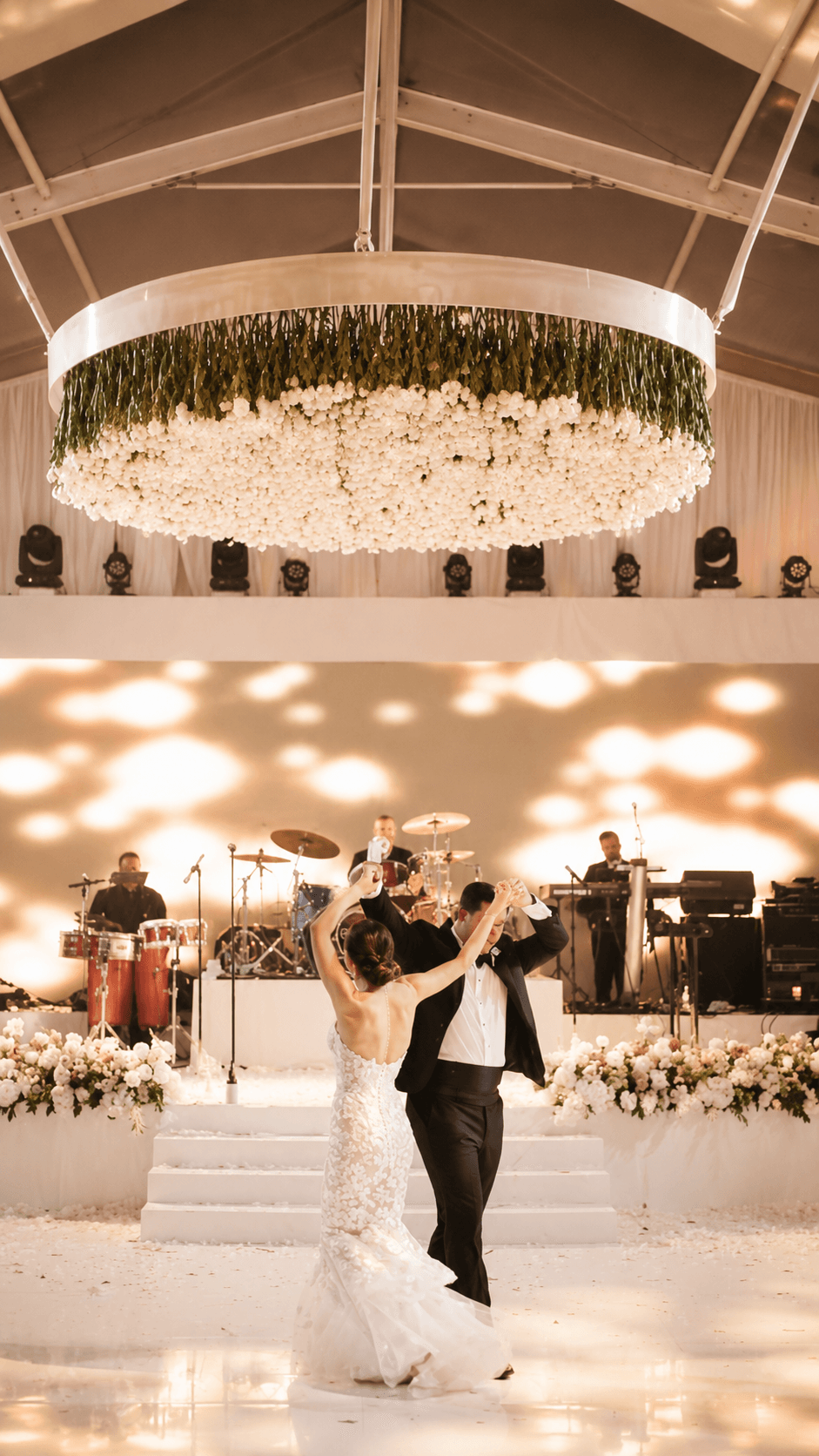 First dance under floral chandelier